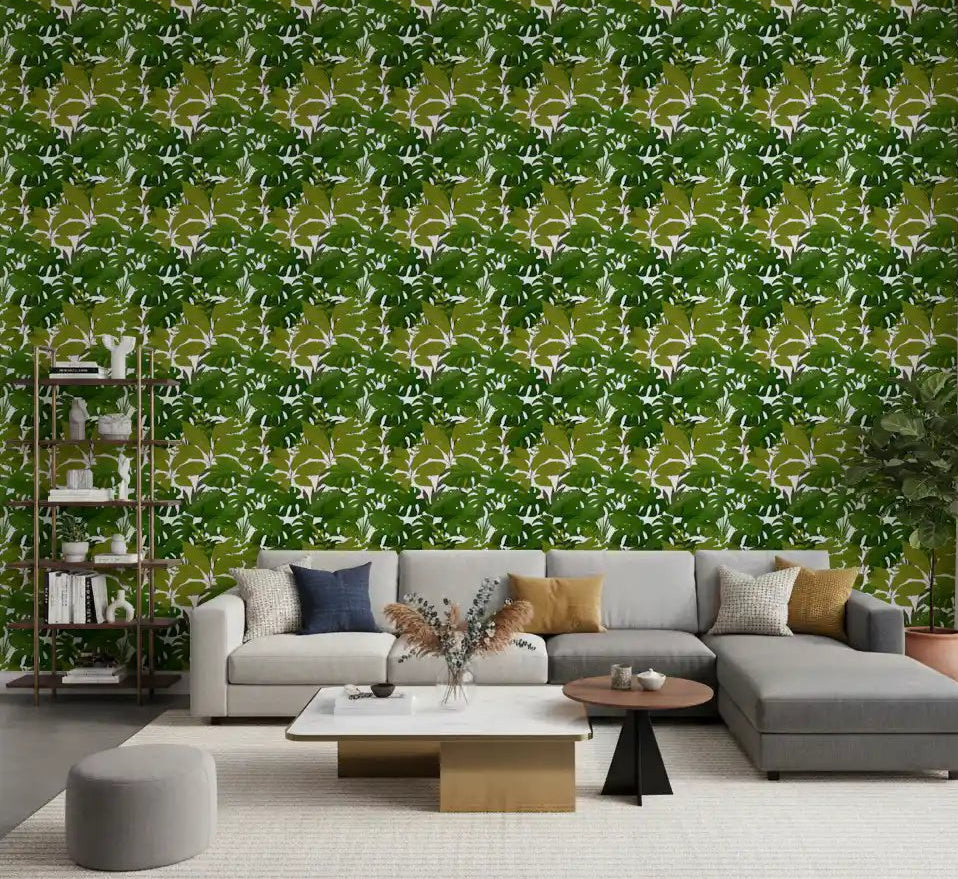 Lush Leaf Canopy Monstera Leaves Wallpaper behind a bright living room sofa
