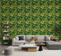 Lush Leaf Canopy Monstera Leaves Wallpaper behind a bright living room sofa