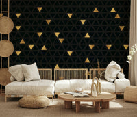 Luxury Black and Gold Triangles Wall Mural behind a tufted headboard.