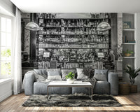 Two large, decorative lamps hang over the bar counter.

