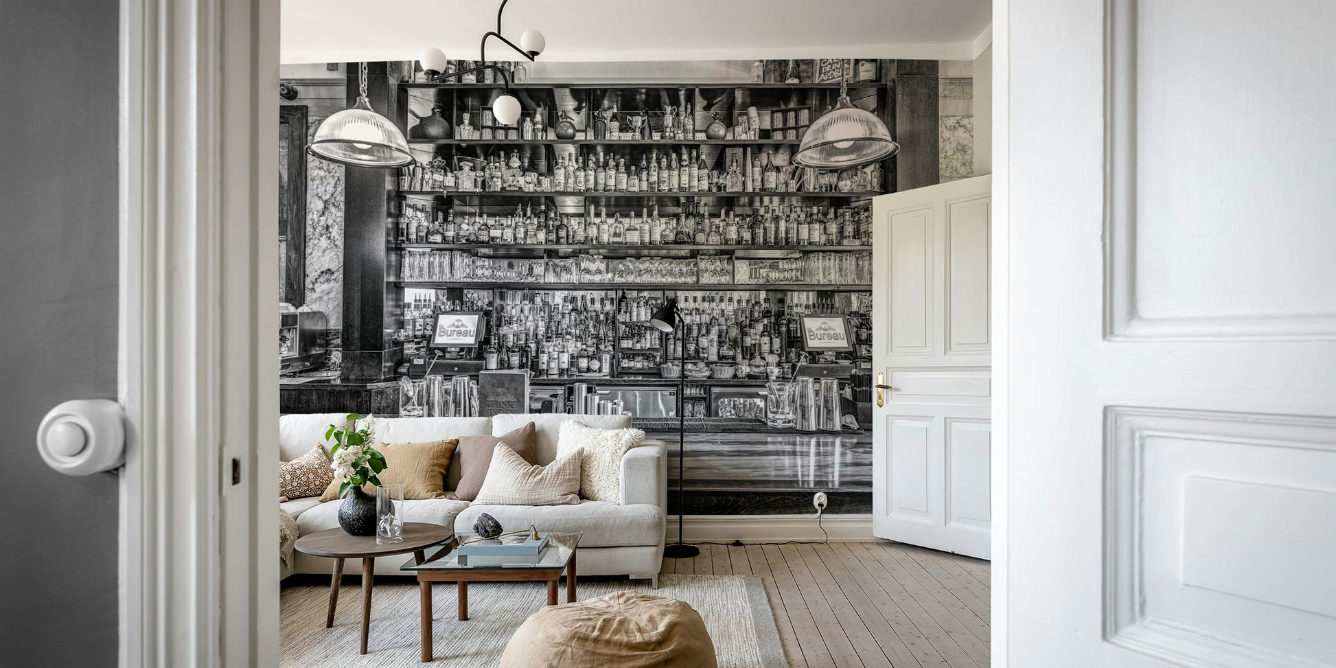 The bar is lined with many shelves of bottles and glasses.

