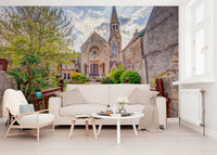 Scenic church entrance in Malmesbury Church Wall Mural with floral surroundings