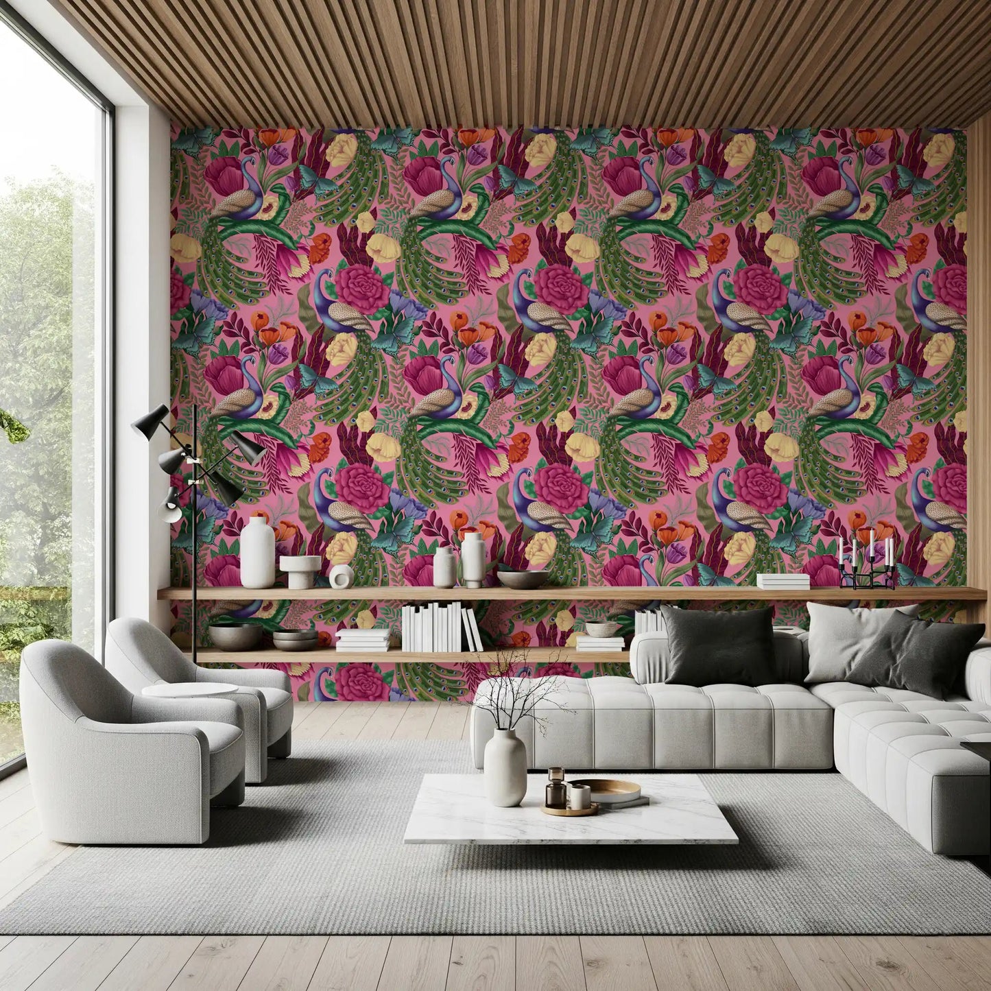 Maximalist Peacock Fantasy Garden Pink Wallpaper behind a modern gray sofa