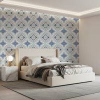 Warm bedroom with Mediterranean Indigo Fleur Tile Wallpaper and cushioned headboard