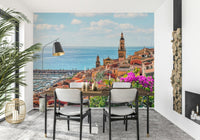 Historical bell tower overlooking a blue Mediterranean Village mural.