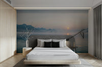 The sun rises, casting a gentle glow through the trees.

