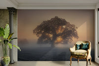 A wall mural of a lone tree in a misty field at sunrise.

