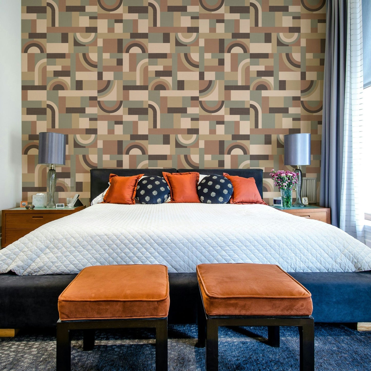 The mural is installed in a calm living room behind a simple, light-colored sofa.

