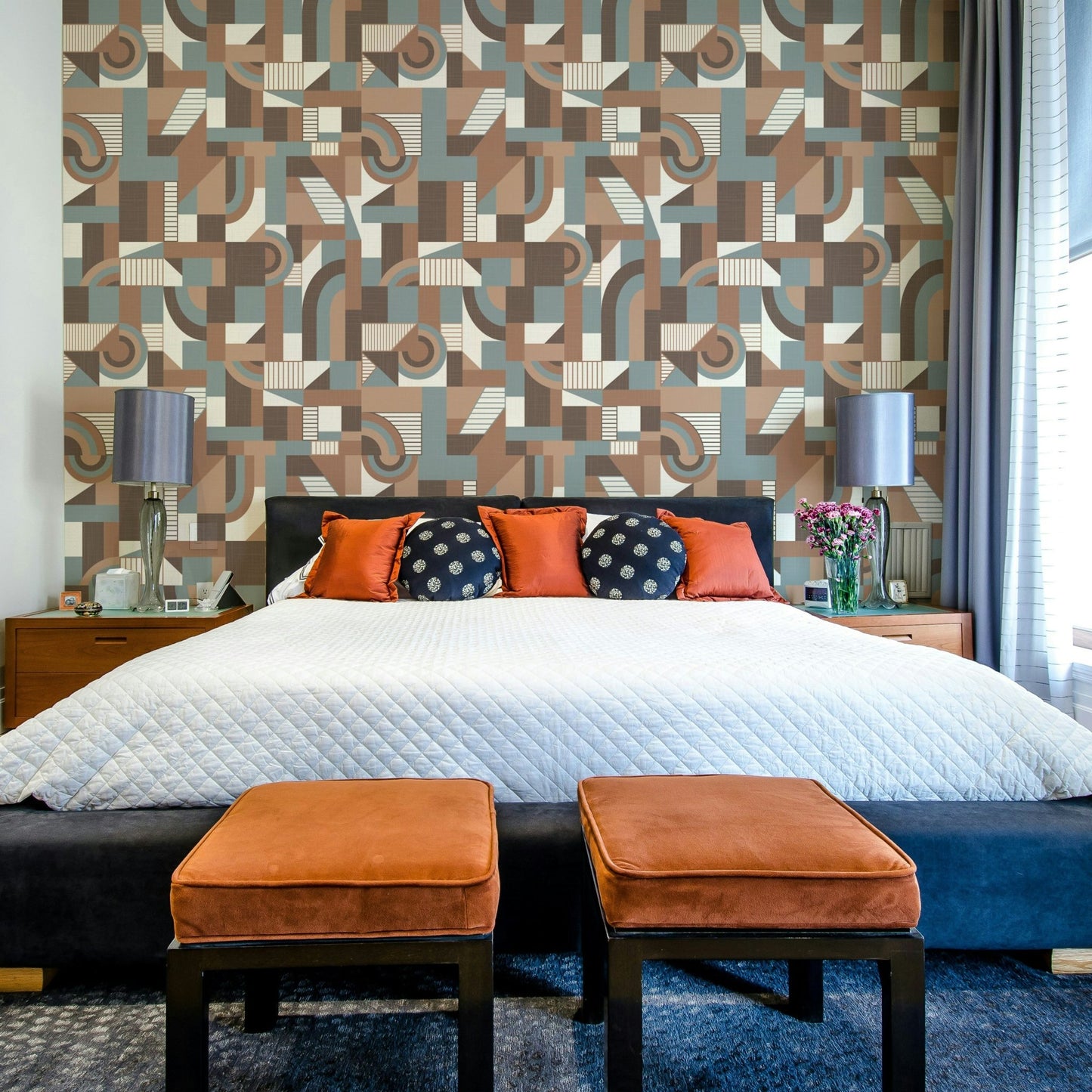 The mural is installed in a calm living room behind a simple, light-colored sofa.

