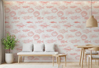 Dining area wall with hand-drawn fish wallpaper in coral and white tones