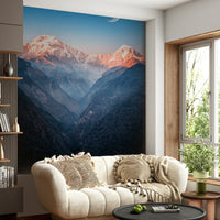 A cozy living area paired with Mystic Peaks at Dusk Wall Mural and glowing snowy peaks