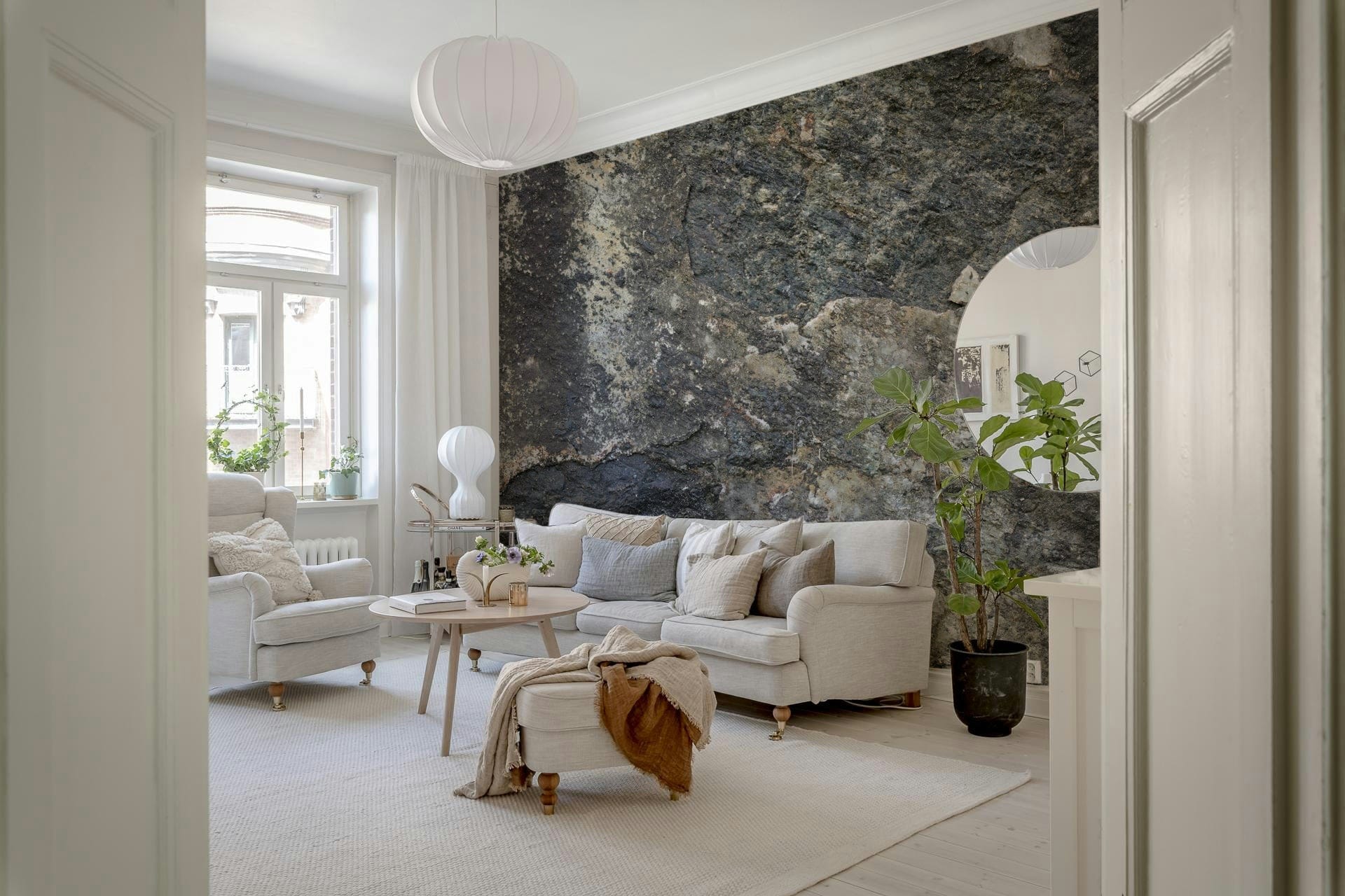 Nature's Rock Wall Mural in a modern living room with a grey leather sofa.