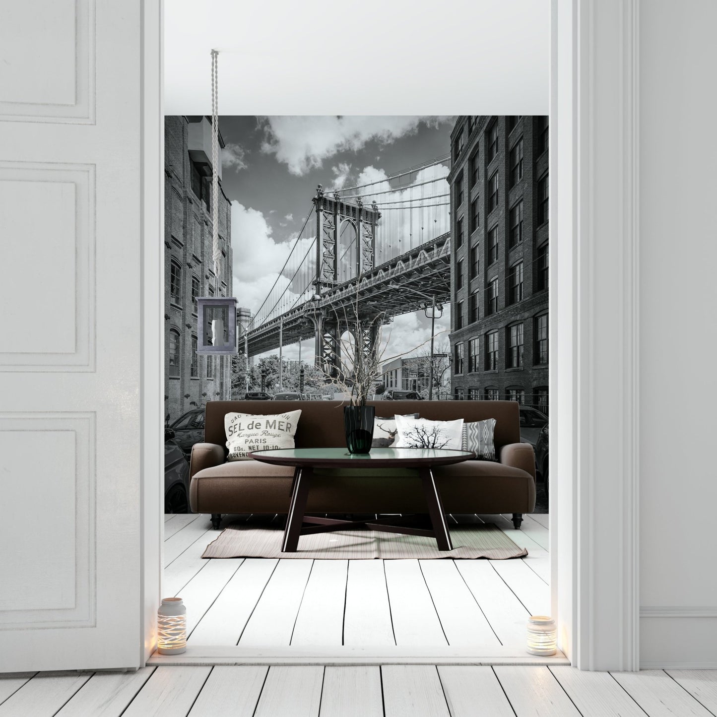 Black-and-white mural of Manhattan Bridge with urban skyline.

