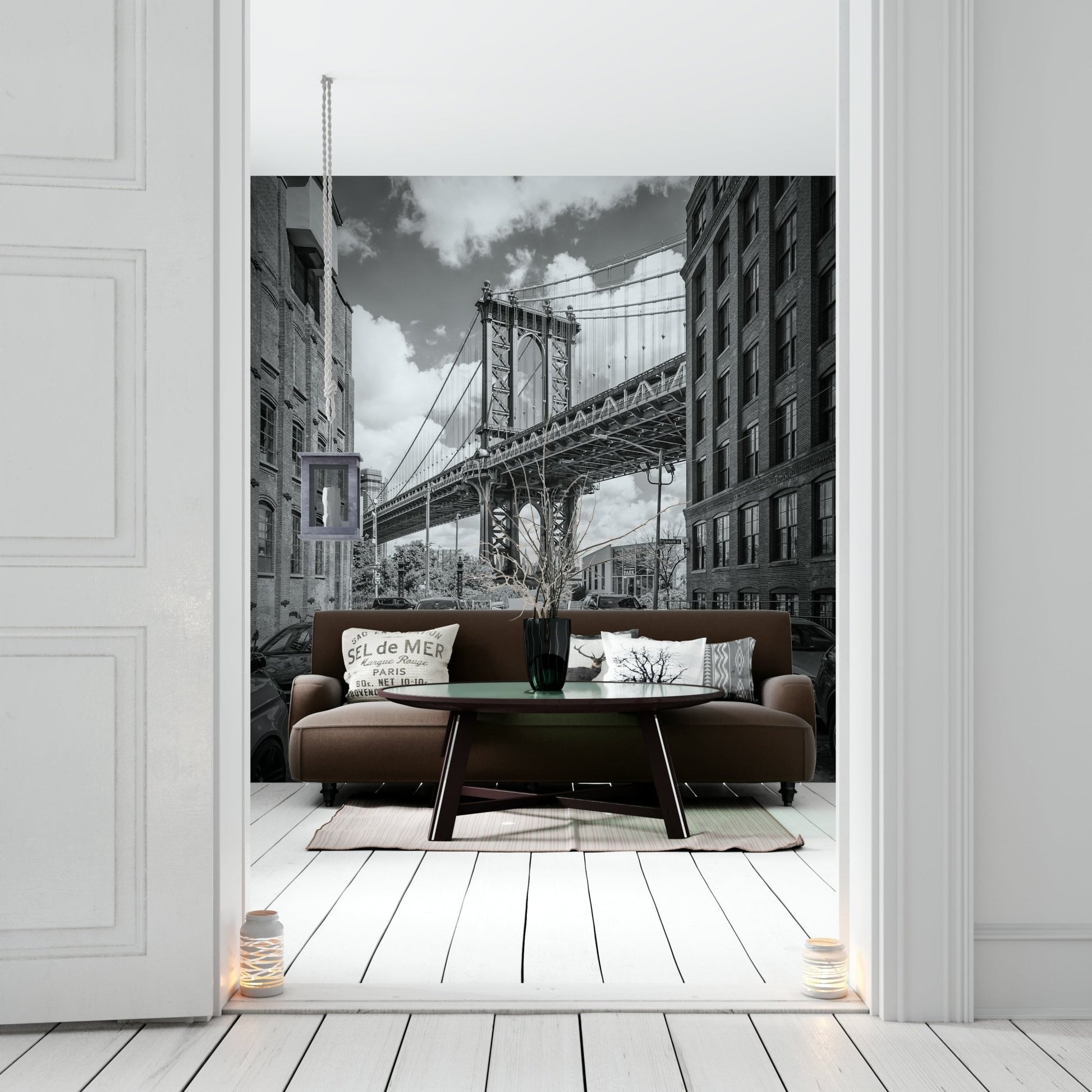 Black-and-white mural of Manhattan Bridge with urban skyline.

