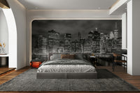 Dramatic mural of Manhattan at night in grayscale tones.


