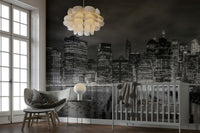 Black-and-white NYC mural with glowing night cityscape.

