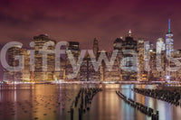 Iconic NYC skyline lit up at night wall mural art.

