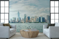 Framed by tall windows, NYC Skyline View Wall Mural gives this sitting room city depth
