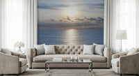 Coastal sunset wallpaper featuring golden light reflecting on gentle waves.