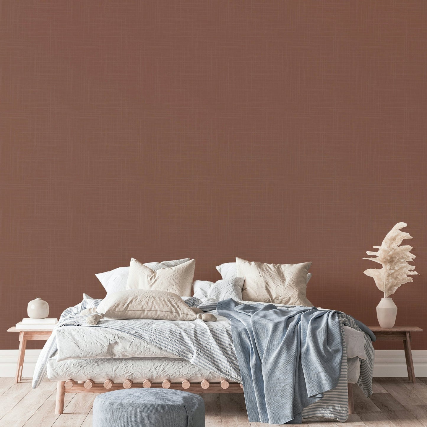 The mural is installed in a rustic living room behind a simple, light-colored sofa.

