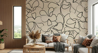 Black ink-like organic curves tracing petals on a cream wall mural., GD5479
