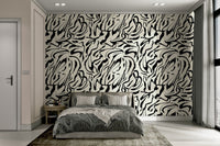 A bedroom with the artistic mural behind the headboard.

