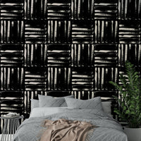 A close-up of a wall with painted stripes wallpaper, showing brushstroke details