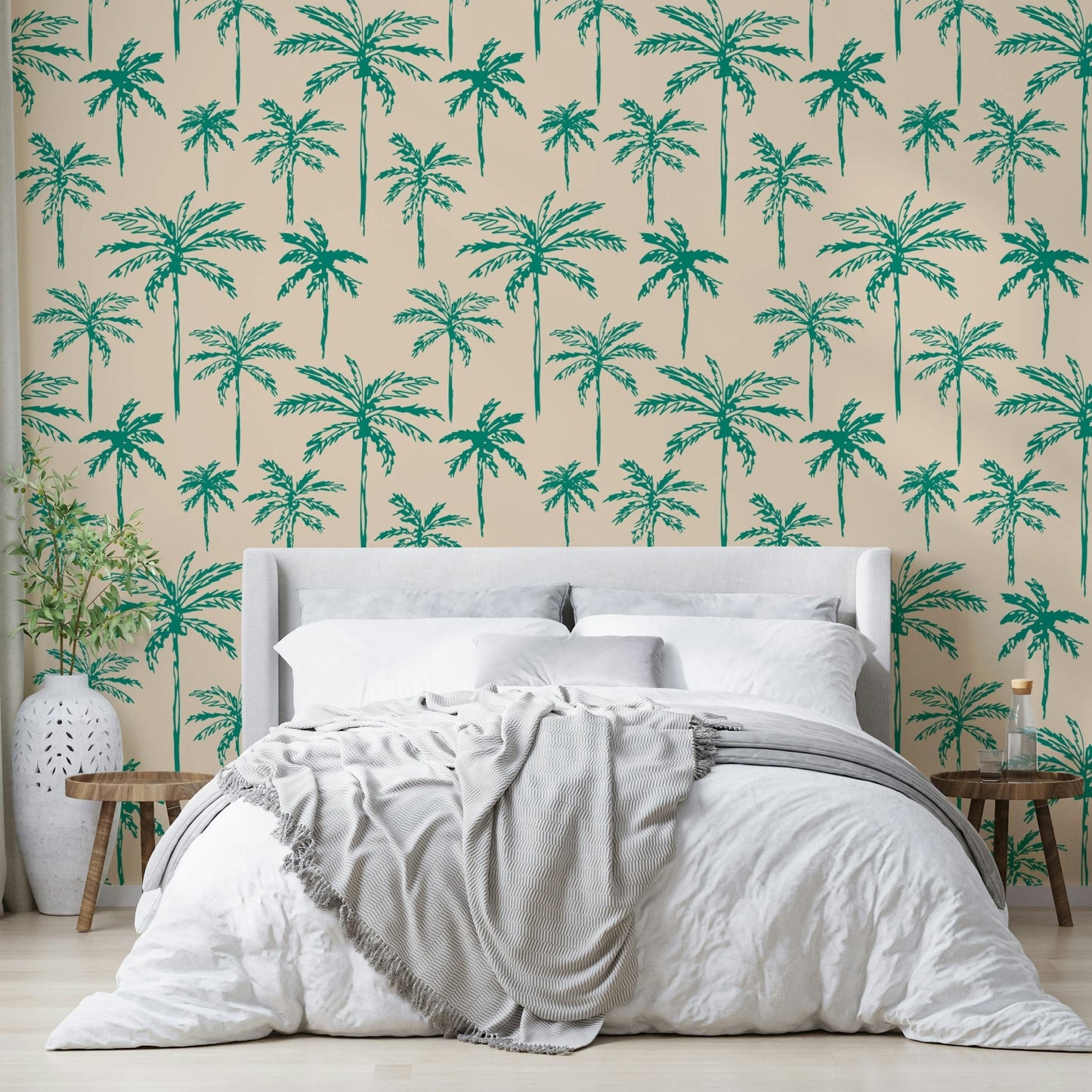 A close-up of a green palm leaf pattern on wallpaper.

