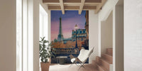 Sunset cityscape wall mural with a cobblestone street and iron railings.