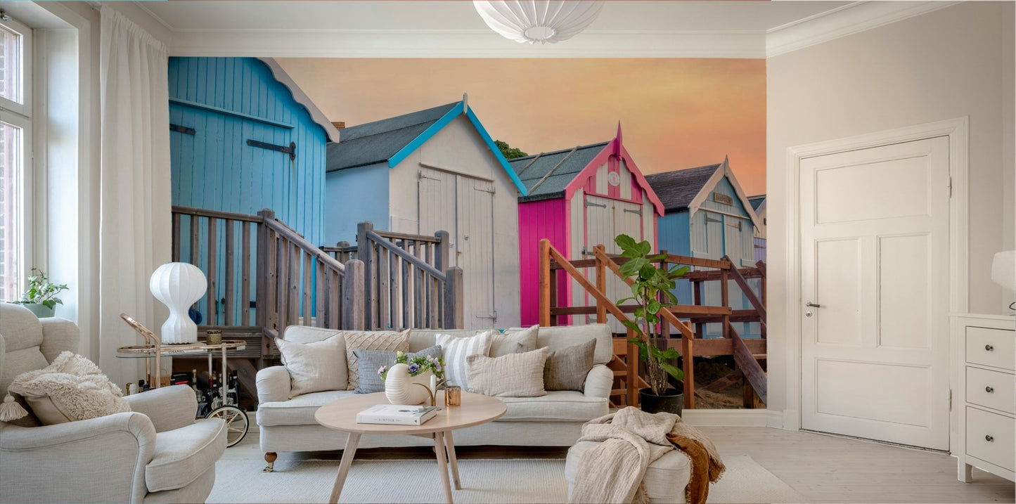 The image shows an artistic impression of a serene beach with huts in soft, muted tones.

