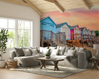 The beach huts and ocean are a central focus of the image.

