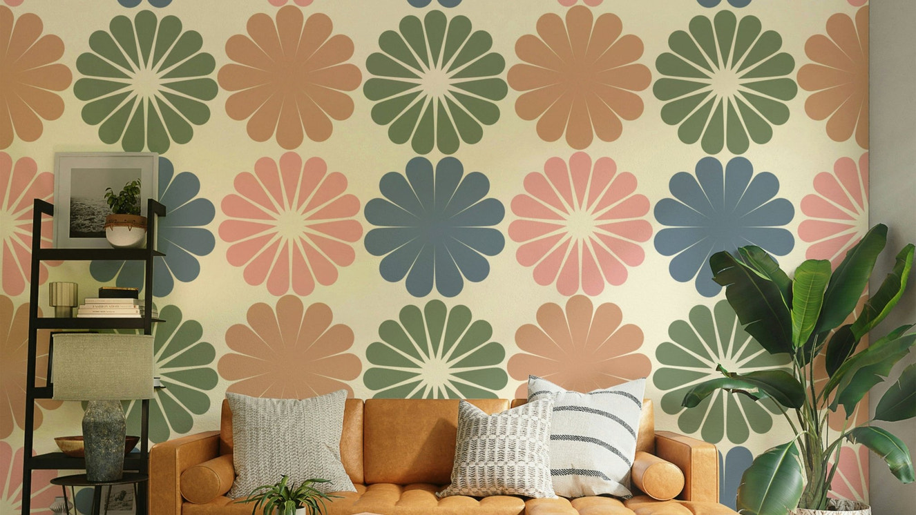A close-up of a pastel geometric flower pattern on wallpaper.

