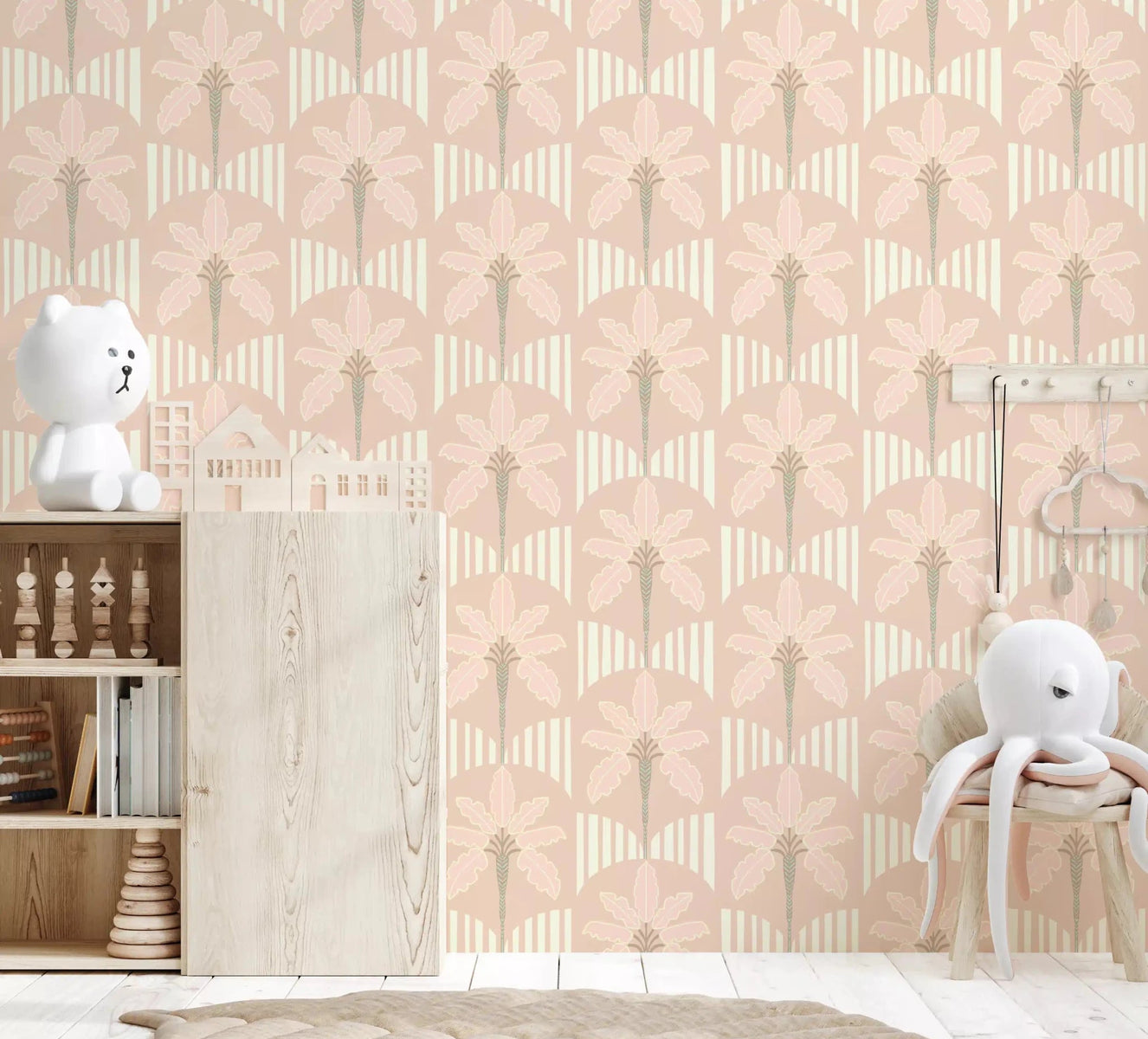Nursery softened by Pastel Palm Haven wallpaper in calm blush pink tones