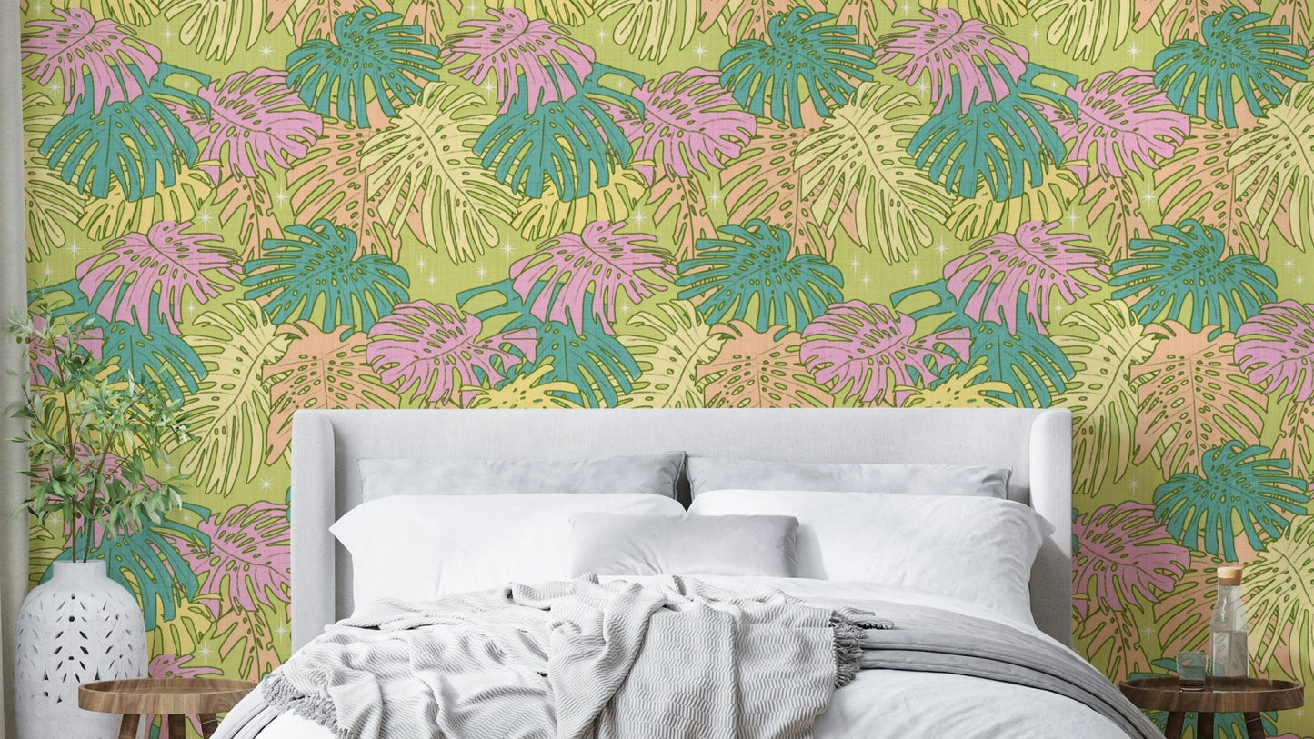Monstera leaves in pastel colors on avocado wall covering

