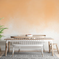 Artistic peach watercolor wallpaper for vibrant living room walls.