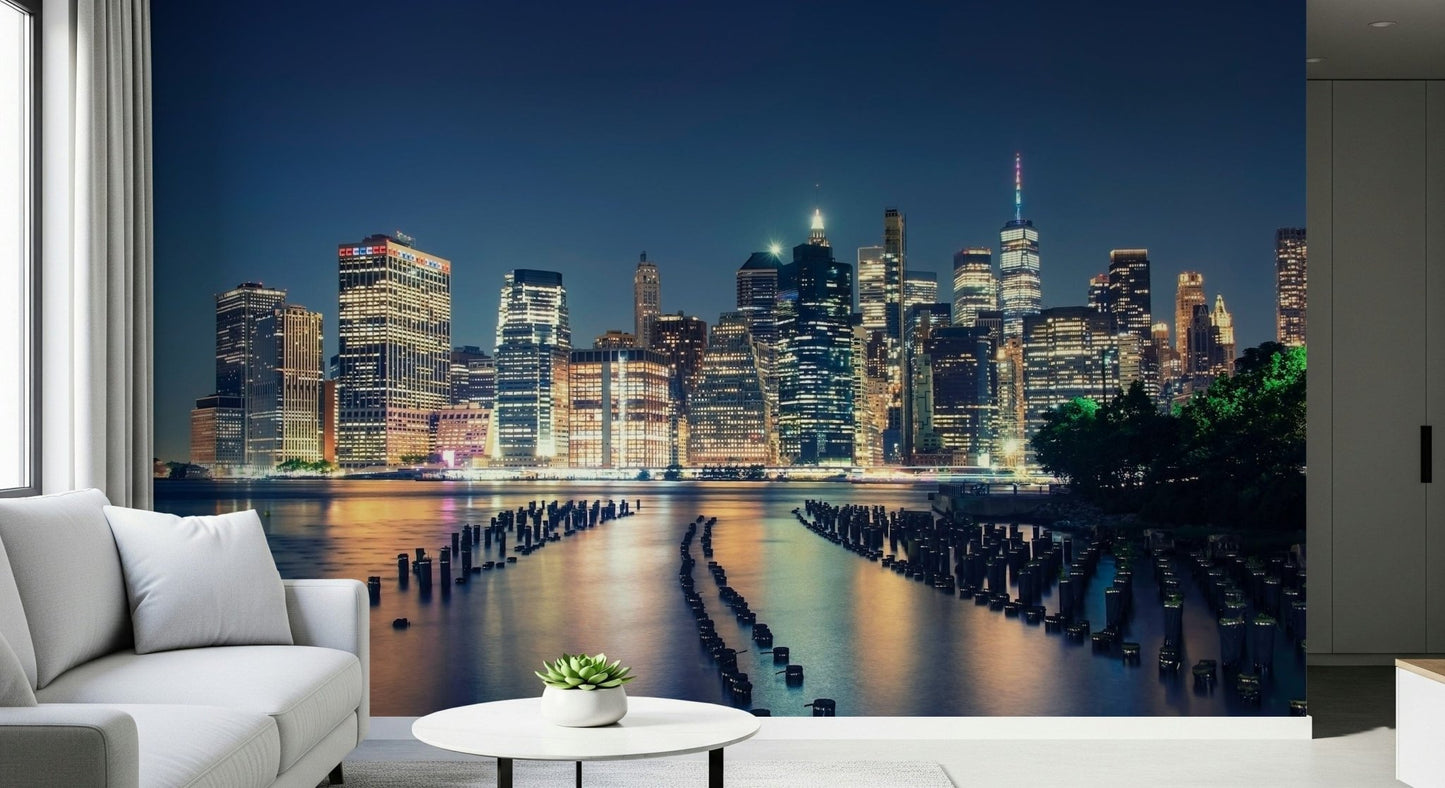 Coastal city lights wallpaper featuring historical pier pilings in the water.