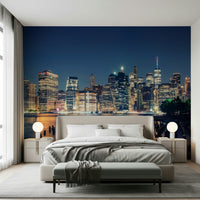 Atmospheric city lights at night wall mural with a calm river view.