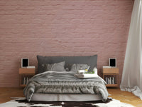 Peaceful room transformation with a pink brick mural.

