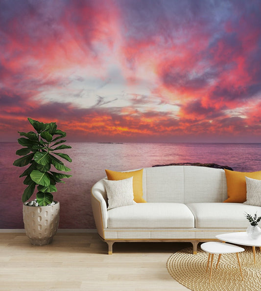 A peaceful wall mural with a sunrise over the ocean.

