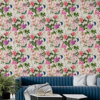A contemporary living room with a pink floral wall mural.

