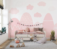 Pink mountain kids wallpaper with white accents and clouds.
