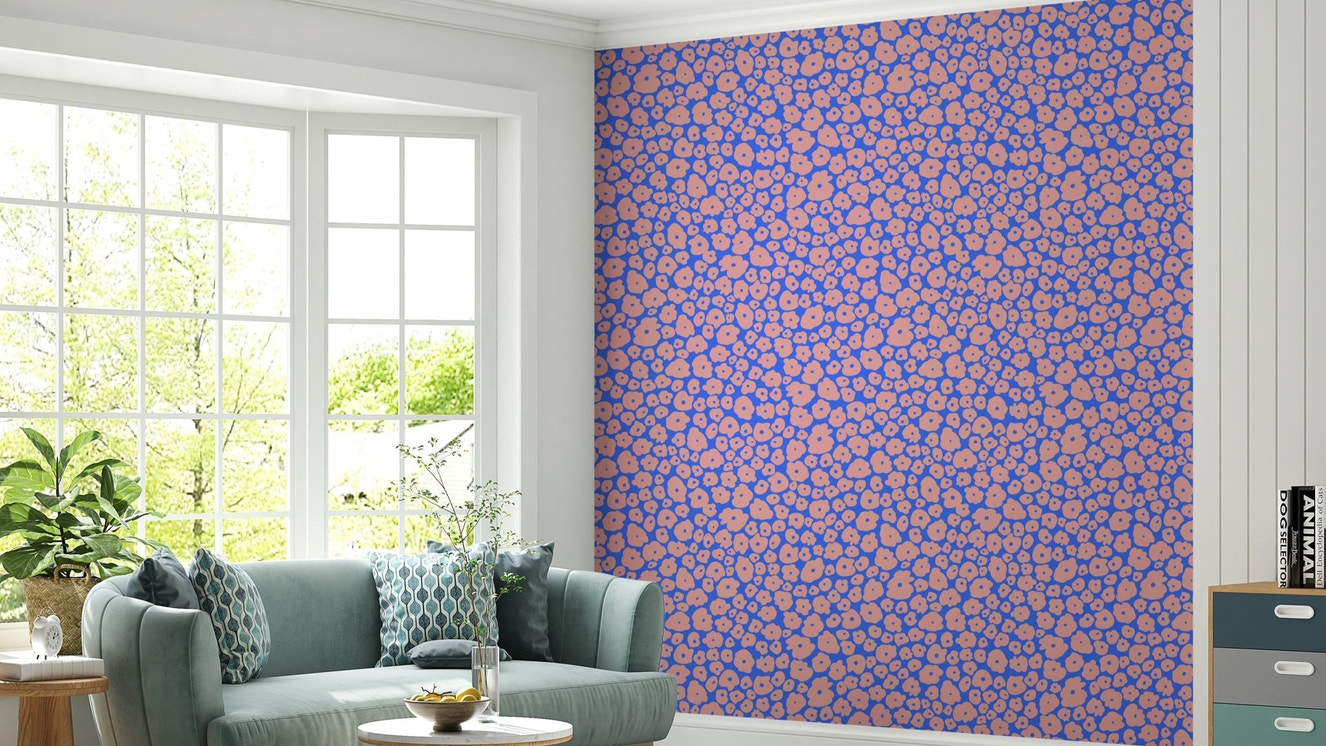 An installation view of the wallpaper being hung on a wall.

