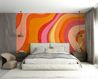 A sunroom decorated with a colorful wavy mural

