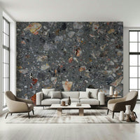 Dark grey wallpaper with multicolored, angular rock inclusions.