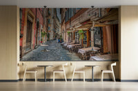 People are sitting at the cafe tables.

