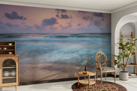 A wall mural of a beach scene at dusk.

