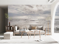 Minimal living room framed by Rough Stormy Sea Wall Mural in soft gray waves