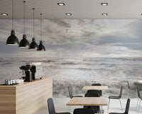 Café area features Rough Stormy Sea Wall Mural with cloudy ocean view