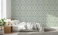 Cozy Bedroom scene with Sage Bloom Tile Wallpaper in a muted green repeat