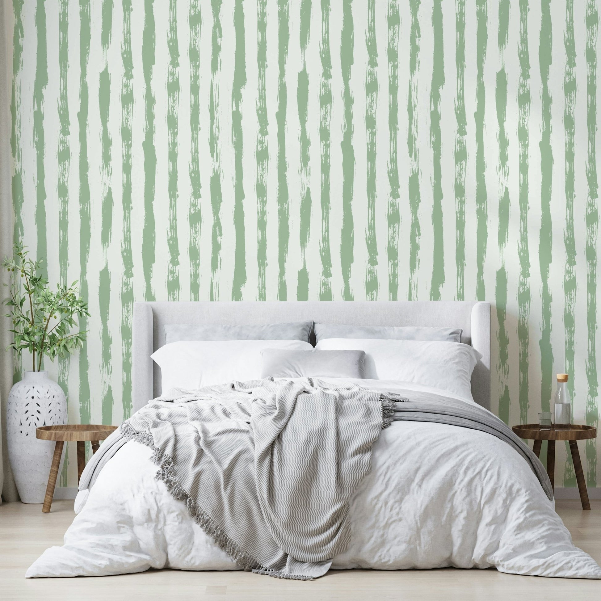 Wallpaper with a gentle sage green and white stripe design

